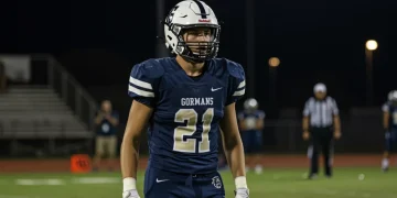 High school football player demonstrating intense focus on the field