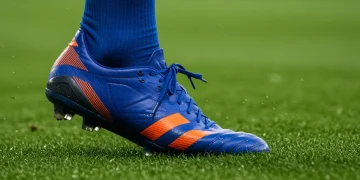 Professional football player's foot in a high-performance boot and advanced football sock, showcasing material and design.