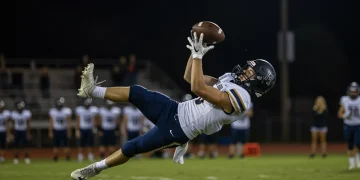 High school football player catching ball for highlight reel