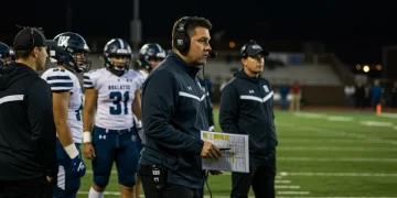 High School Football Coaching Strategies: New for 2025 High school football coach strategizing during a game