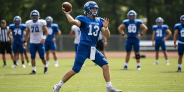 High school quarterback throwing football in practice