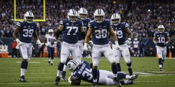 Dominant NFL defense celebrating a crucial sack in a brightly lit stadium.