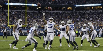 Special teams unit blocking a punt during a critical NFL game