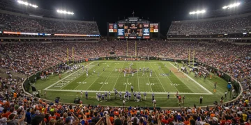 USFL playoff game with intense action and cheering fans in a packed stadium.