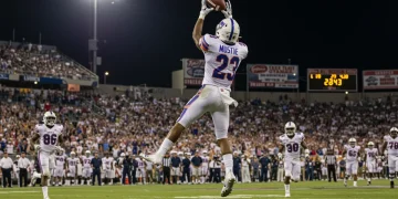USFL receiver making a dynamic catch during a thrilling night game