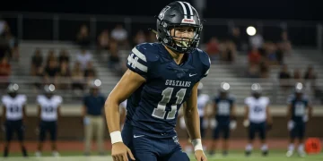 High school football player in action on the field, focused and determined
