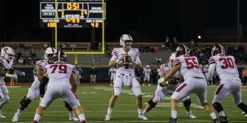 NFL quarterback executing a game-winning drive in a high-stakes moment, under stadium lights.